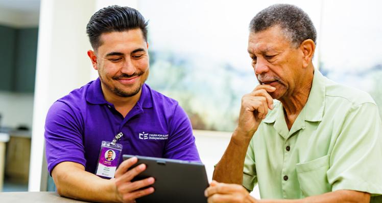 Caregiver Showing a Tablet to a Elder Senior