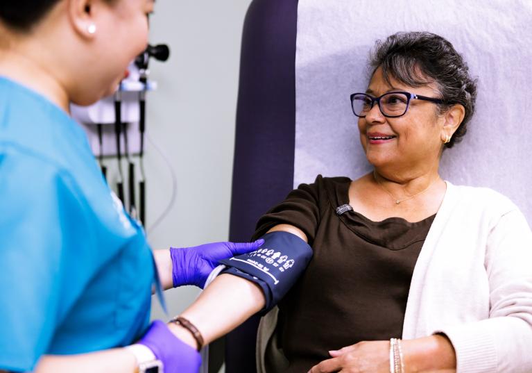 Nurse taking blood pressure of an elderly patient