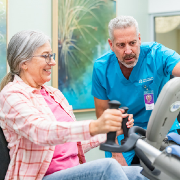 Doctor Assisting a Elderly Woman Doing Exercise