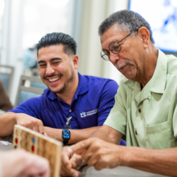 Volunteer with Patient Playing a Game