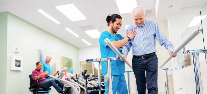 Caregiver Helping Walk Patient